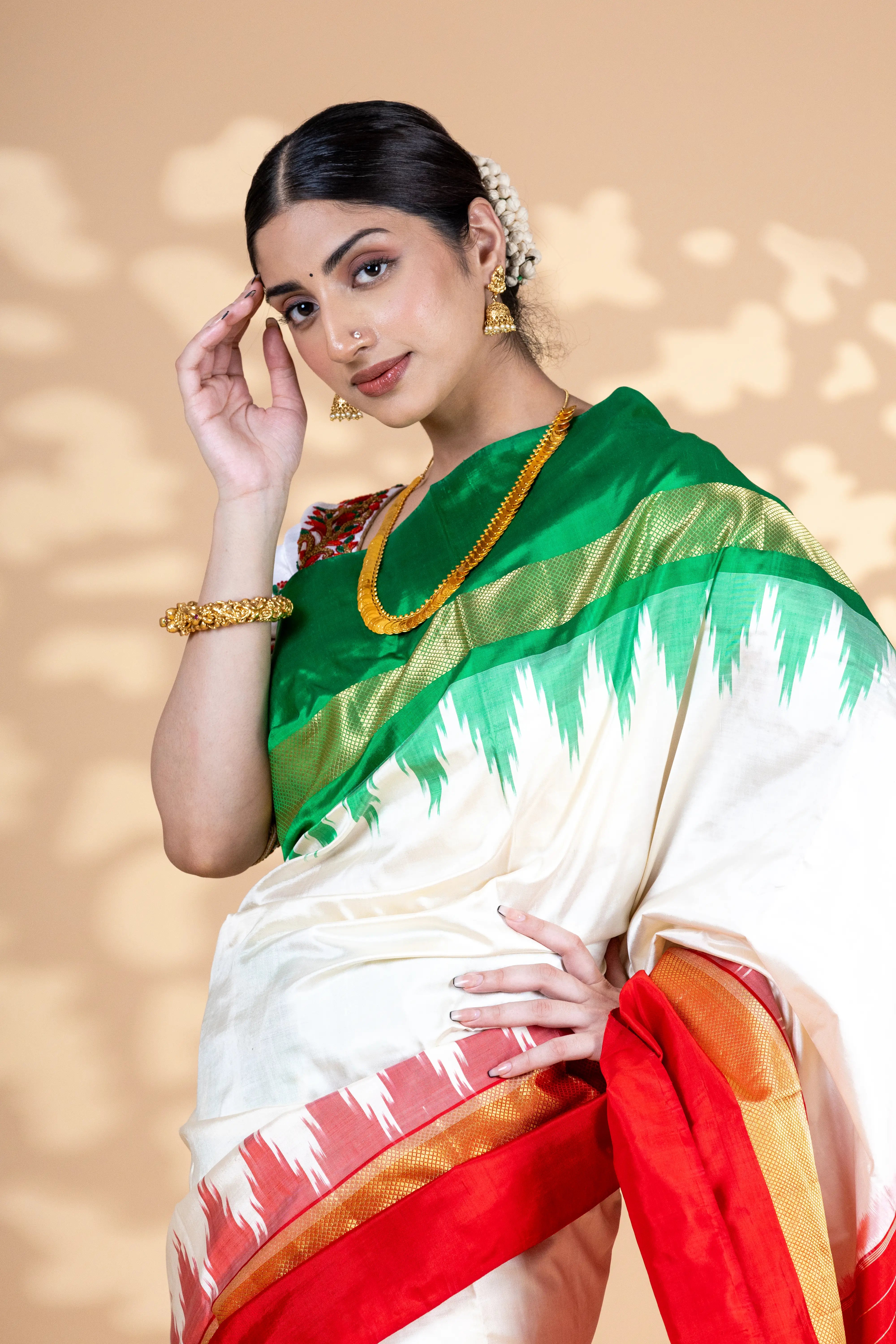 White Pochampally Saree With Contrast Red And Green Zari Border With Ikkat Detailing